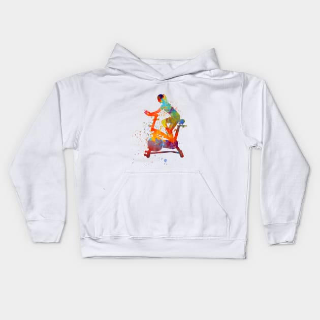 woman riding an exercise spin bike in the gym Kids Hoodie by PaulrommerArt
